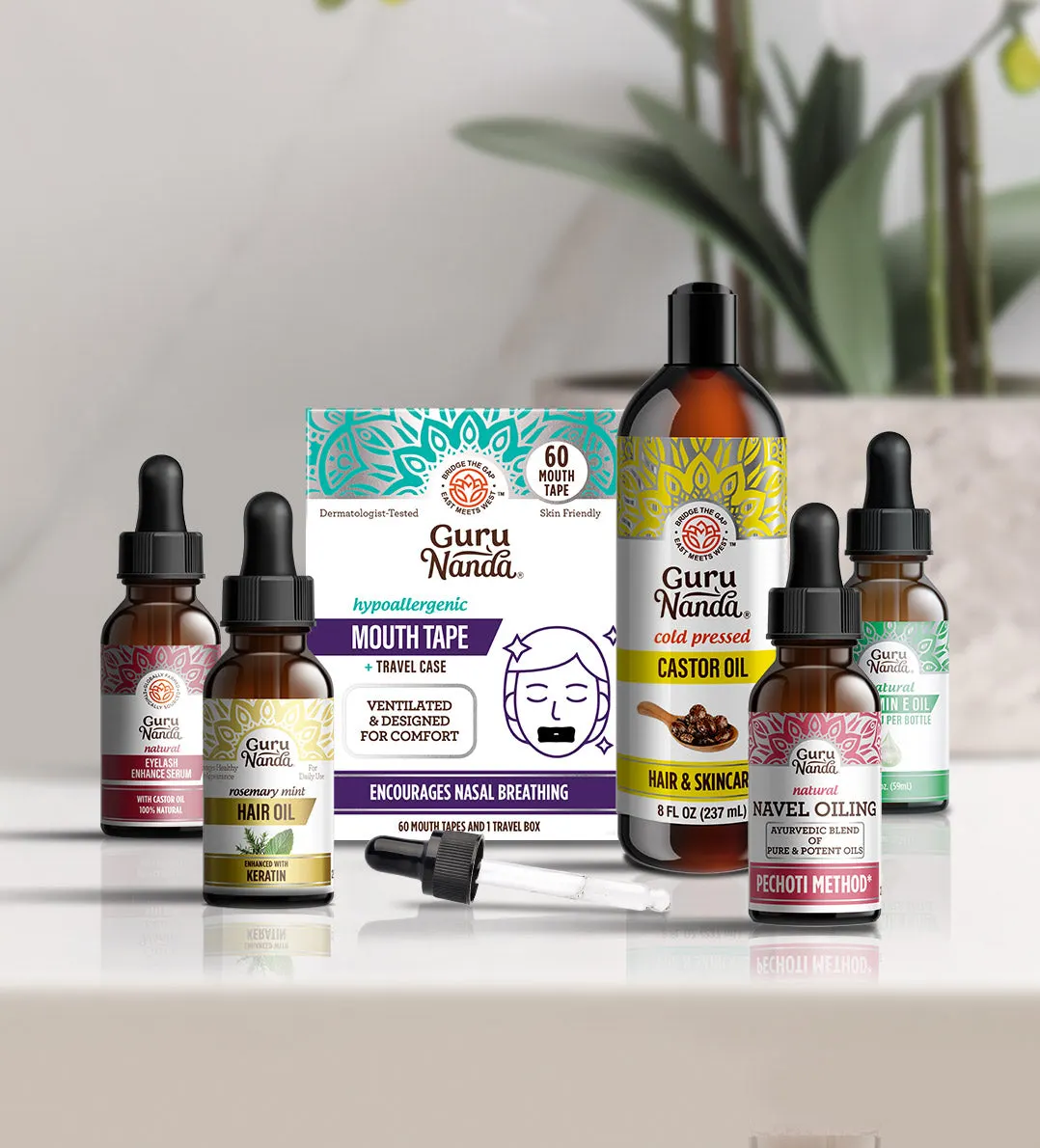 GuruNanda mouth tape, castor oil and navel oil bottles on a bathroom shelf